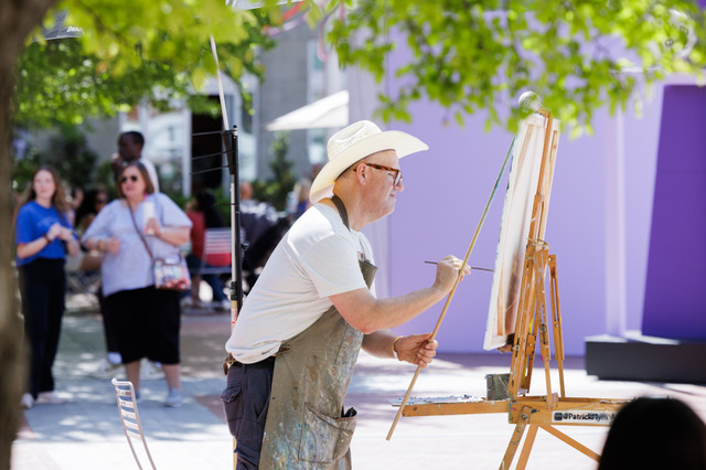 An artists live painting at the Fort Worth Art Fair in Sundance Square.